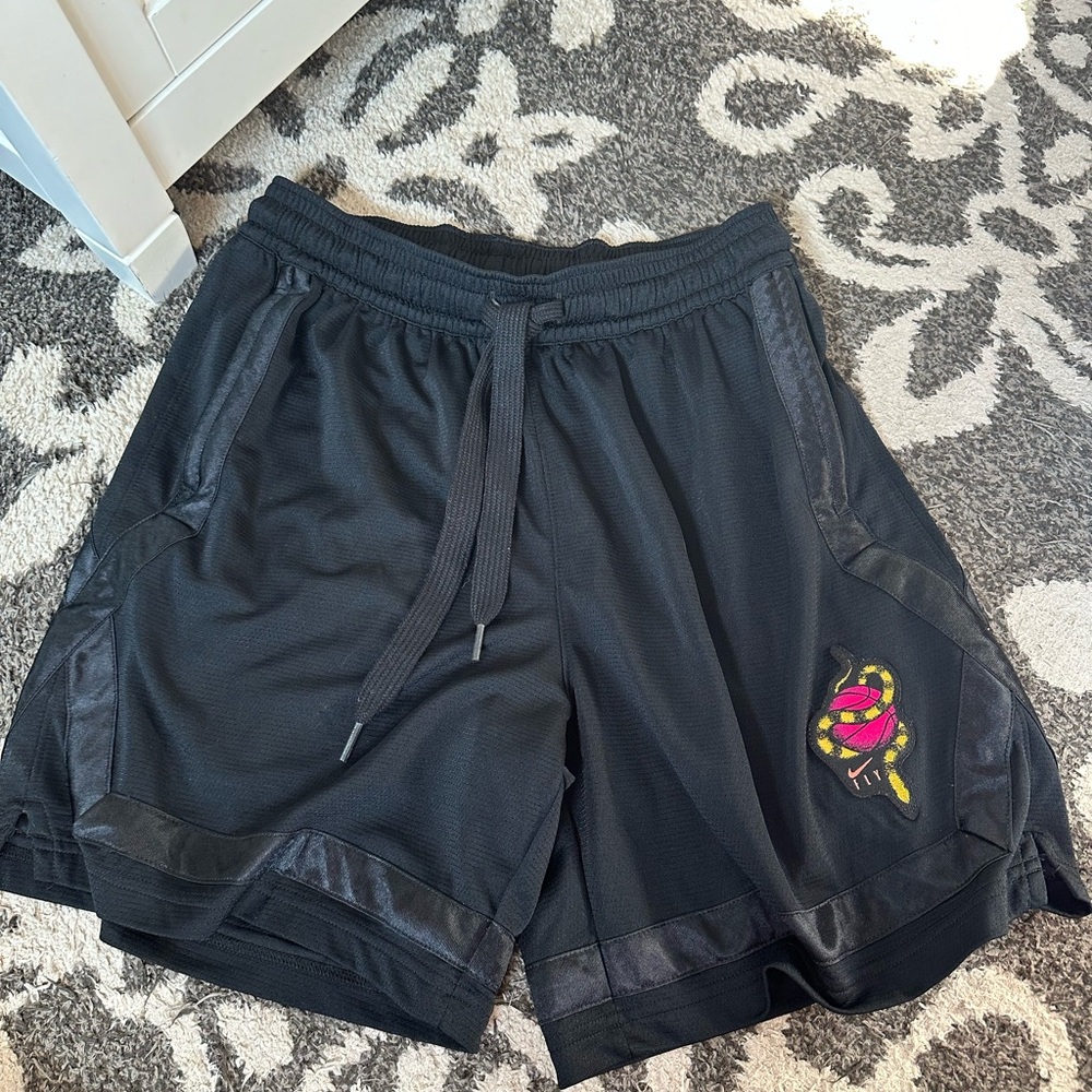 Black and pink Nike basketball shorts